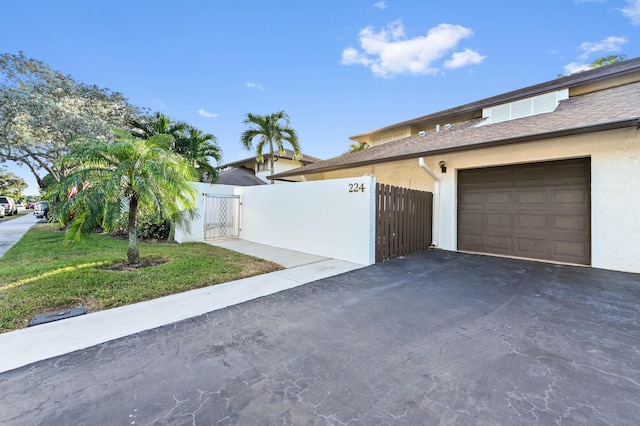 view of home's exterior with a lawn and a garage