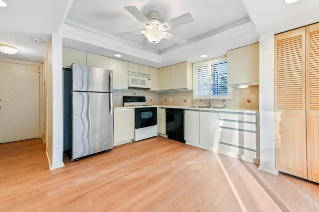 kitchen featuring tasteful backsplash, white appliances, ceiling fan, sink, and light hardwood / wood-style floors