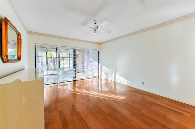 unfurnished room featuring ceiling fan, wood-type flooring, and a textured ceiling