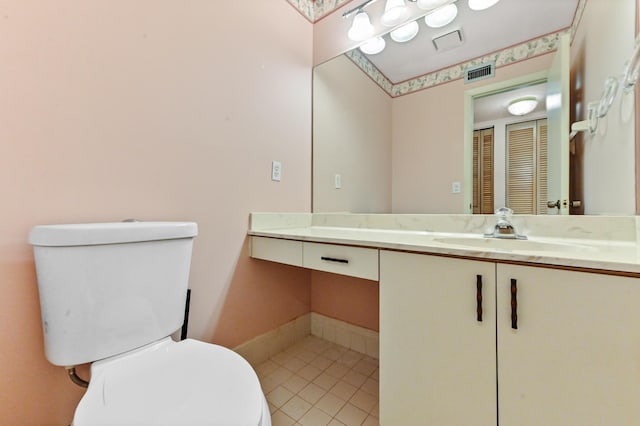 bathroom featuring tile patterned floors, vanity, and toilet