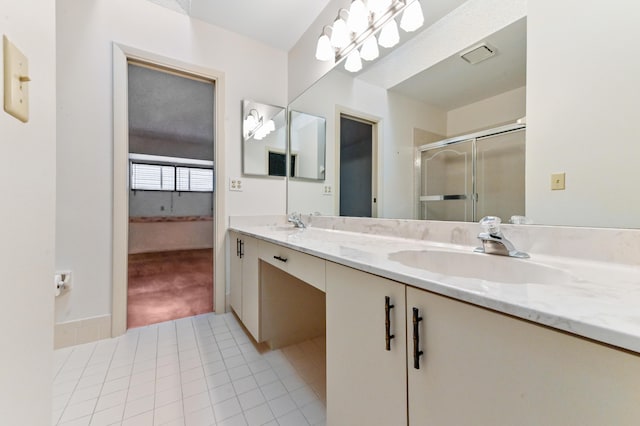 bathroom with tile patterned floors, vanity, and a shower with door