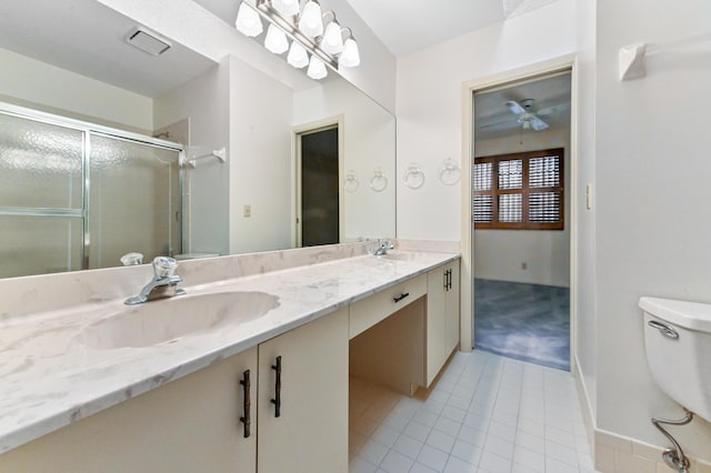 bathroom featuring tile patterned flooring, vanity, toilet, and an enclosed shower