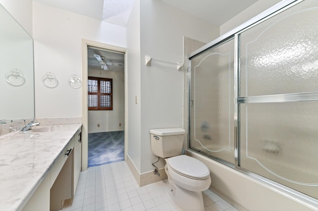 full bathroom featuring toilet, vanity, tile patterned floors, and enclosed tub / shower combo