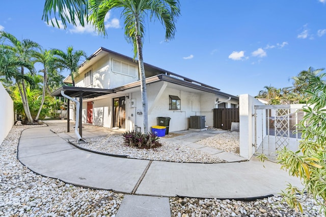 back of property featuring a patio and cooling unit