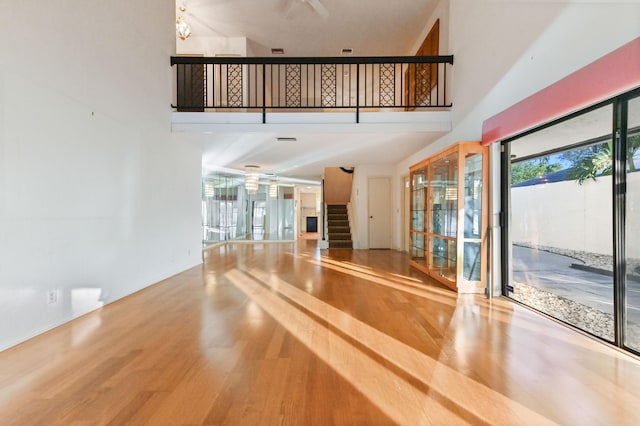 interior space featuring wood-type flooring and a high ceiling