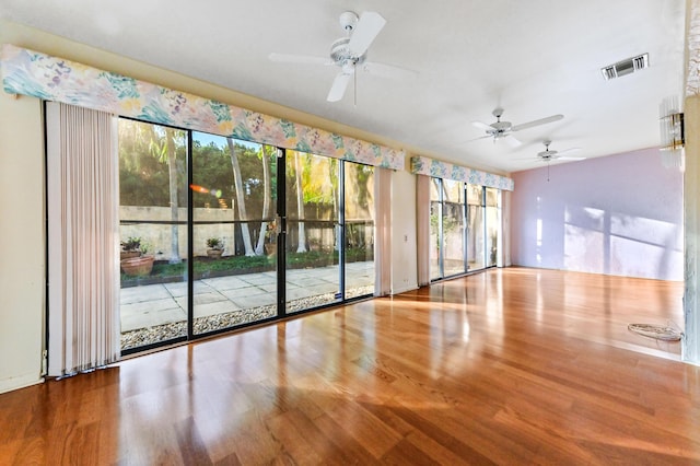 spare room with ceiling fan and wood-type flooring