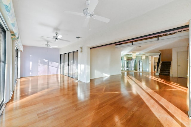 empty room with light hardwood / wood-style flooring and ceiling fan