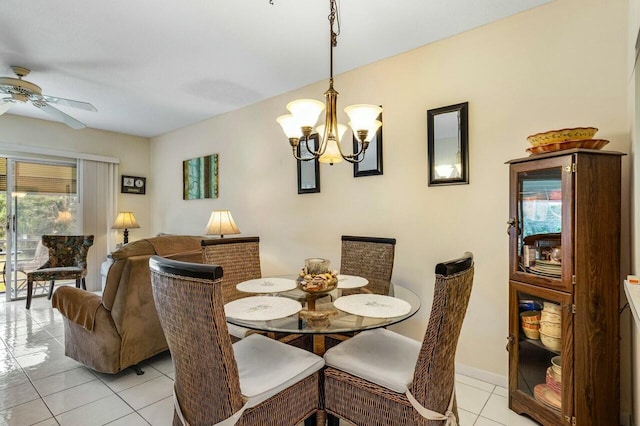 dining room with ceiling fan with notable chandelier, a healthy amount of sunlight, and light tile patterned flooring