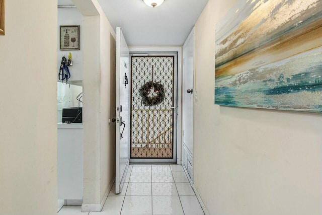 doorway to outside featuring light tile patterned floors