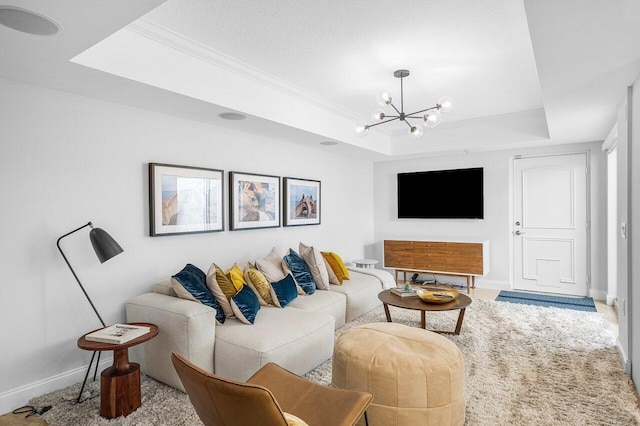 carpeted living room featuring an inviting chandelier, crown molding, and a tray ceiling