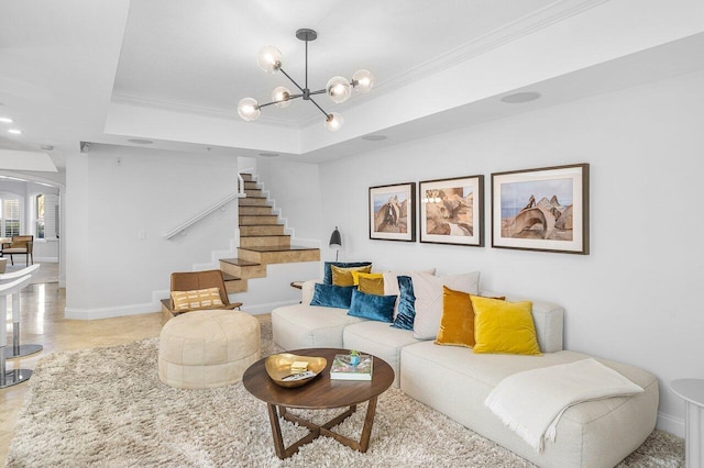 living room featuring a chandelier, a raised ceiling, and crown molding