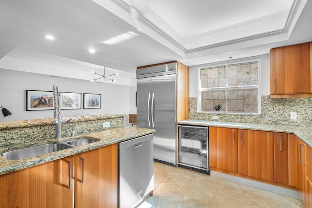 kitchen featuring sink, wine cooler, backsplash, a tray ceiling, and appliances with stainless steel finishes