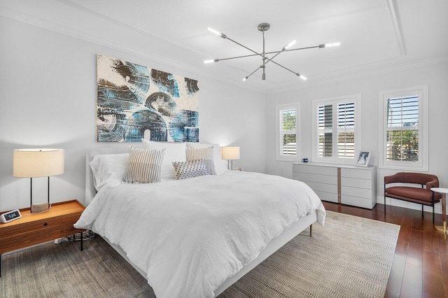 bedroom featuring dark hardwood / wood-style floors, crown molding, and an inviting chandelier