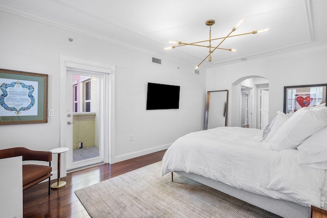 bedroom with crown molding, dark hardwood / wood-style floors, and a notable chandelier