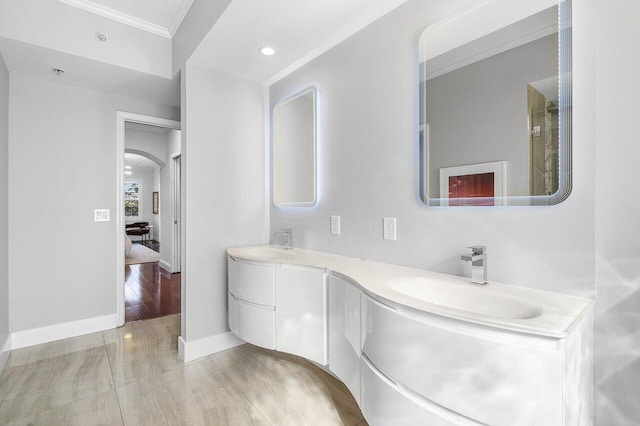 bathroom featuring crown molding, vanity, and hardwood / wood-style flooring