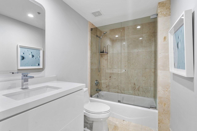 full bathroom featuring vanity, enclosed tub / shower combo, and toilet