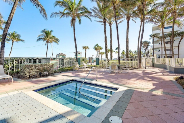 view of pool with a hot tub