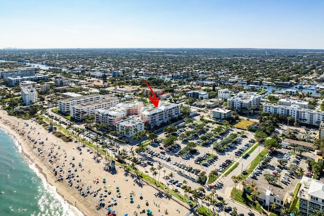 drone / aerial view with a water view and a beach view