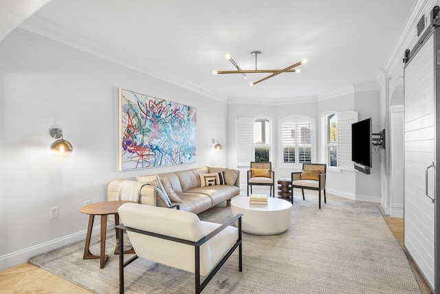 living room with a barn door, a chandelier, light wood-type flooring, and ornamental molding