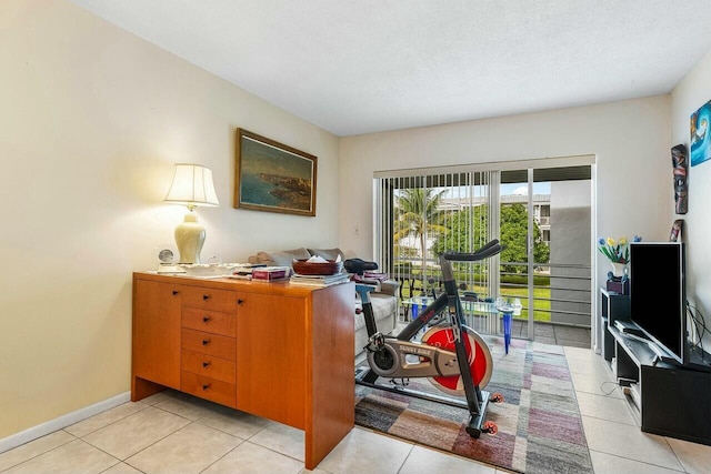 home office with a textured ceiling and light tile patterned flooring