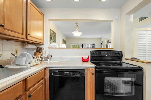 kitchen with black appliances, sink, and tasteful backsplash