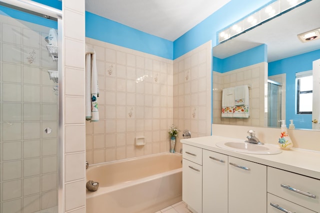 bathroom featuring plus walk in shower, vanity, and tile patterned floors