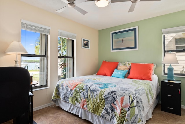 tiled bedroom with ceiling fan