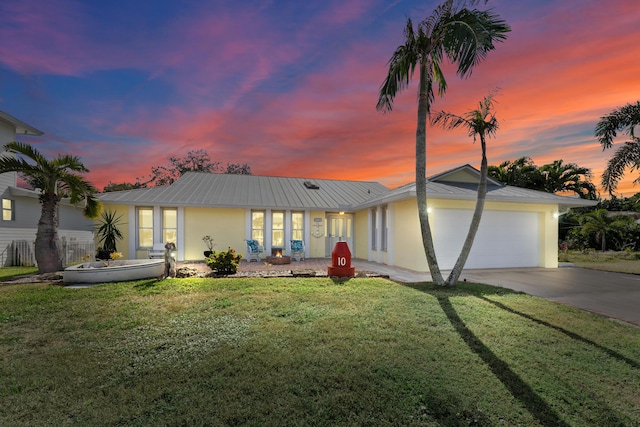 view of front of house with a garage and a lawn