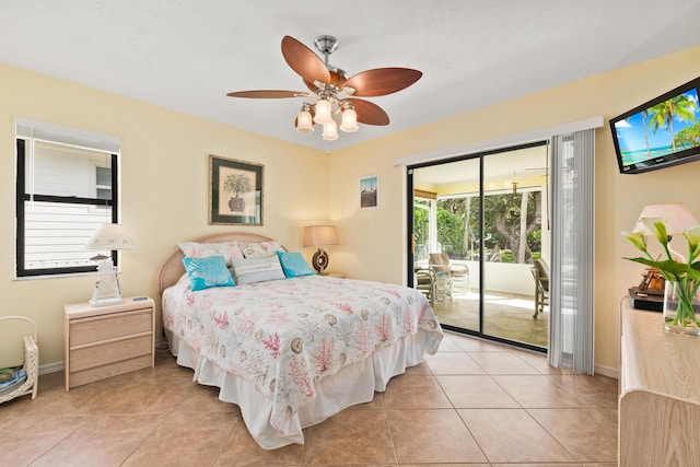 tiled bedroom featuring ceiling fan, access to outside, and multiple windows