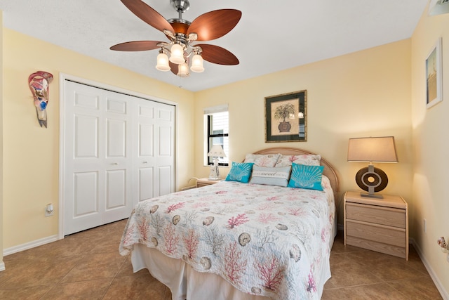 bedroom featuring ceiling fan, light tile patterned flooring, and a closet