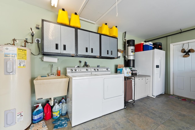 clothes washing area featuring cabinets, electric water heater, washer and clothes dryer, sink, and tile patterned flooring