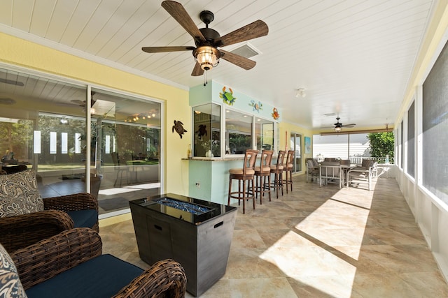 sunroom / solarium featuring ceiling fan and wooden ceiling