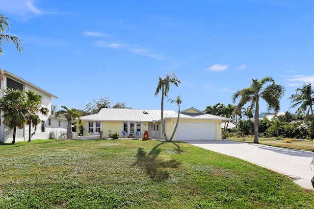 single story home featuring a front lawn and a garage