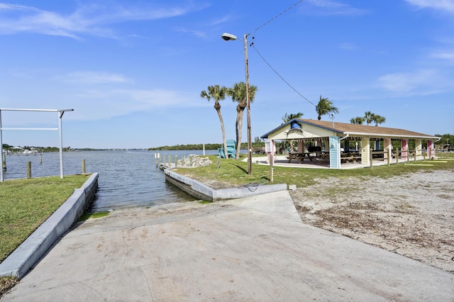 view of dock with a gazebo and a water view