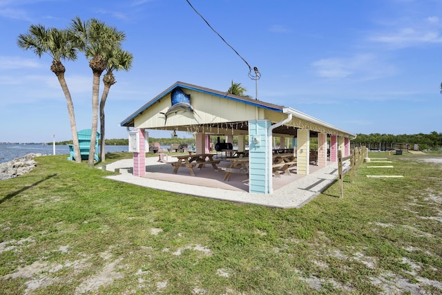 exterior space with a gazebo, a patio area, and a water view