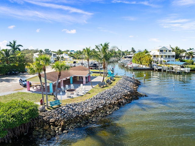 water view featuring a boat dock and an outdoor fire pit