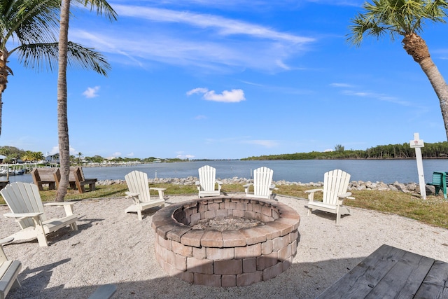 view of patio with a water view and an outdoor fire pit