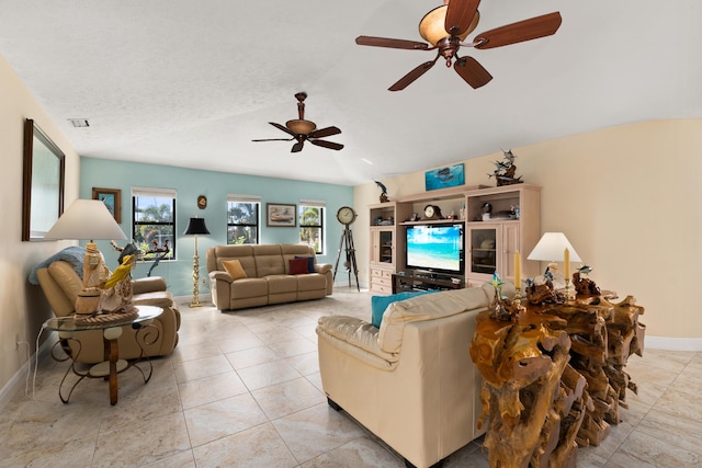 tiled living room with ceiling fan, lofted ceiling, and a textured ceiling