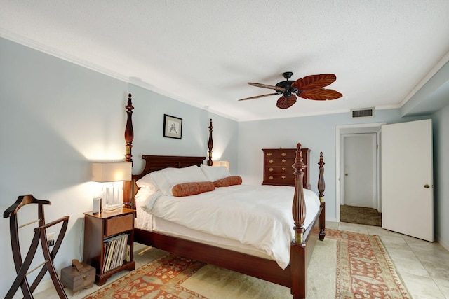 tiled bedroom with a textured ceiling, ceiling fan, and ornamental molding