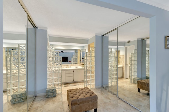 bathroom with tile patterned flooring, ceiling fan, and ornamental molding