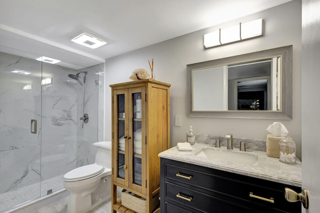 bathroom featuring vanity, toilet, and walk in shower