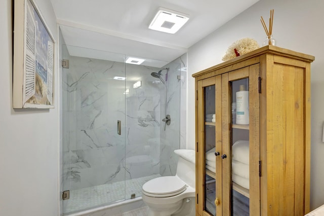 bathroom with a shower with door and toilet