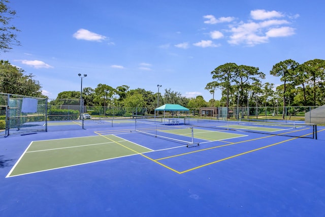 view of tennis court featuring basketball hoop