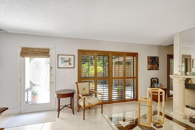 sitting room with light tile patterned floors and a textured ceiling