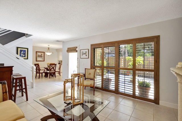 living room with light tile patterned floors and a textured ceiling