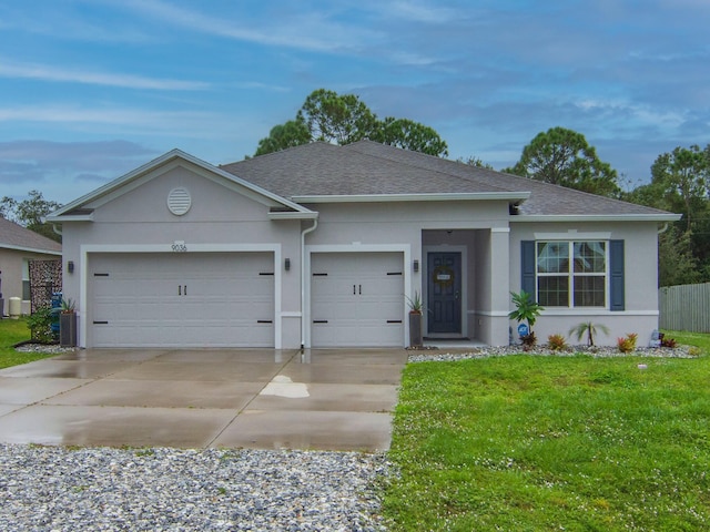 single story home with a front yard and a garage