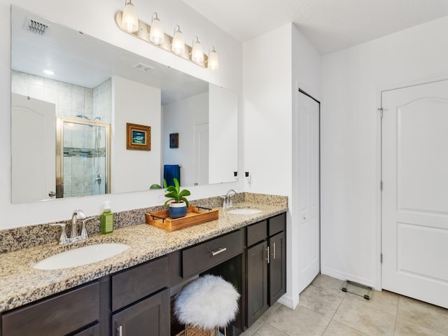 bathroom with tile patterned flooring, vanity, and an enclosed shower