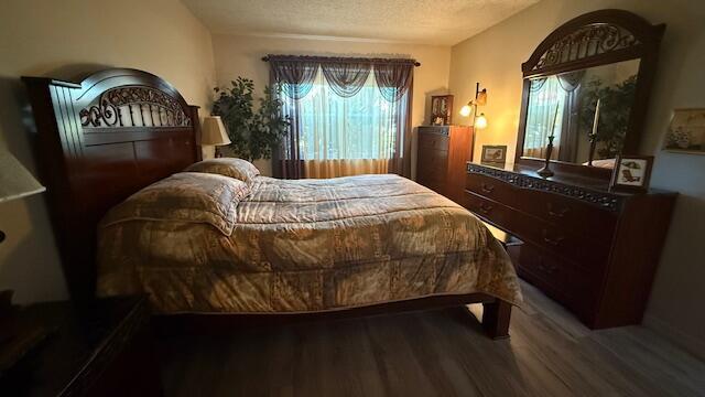 bedroom with hardwood / wood-style flooring and a textured ceiling