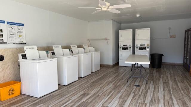 laundry area with ceiling fan, hardwood / wood-style floors, stacked washer / drying machine, and independent washer and dryer