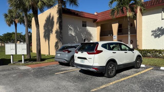 view of parking featuring mail boxes